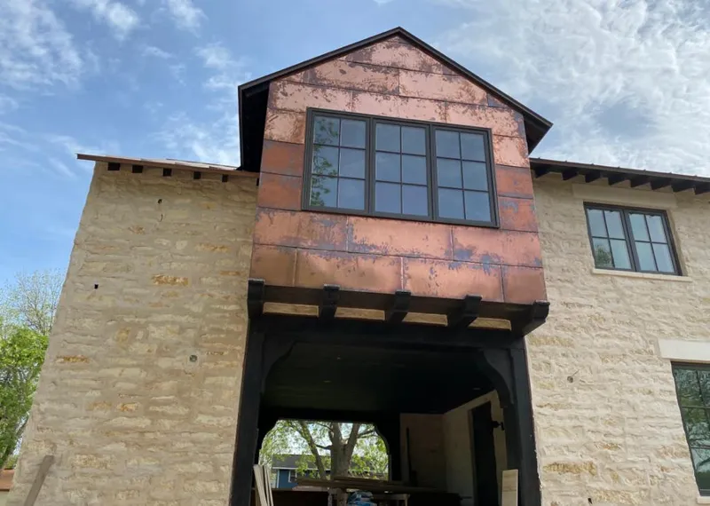 Copper metal panel facade on a stone building for Roof Repair in Wickliffe